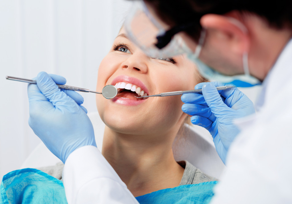 Dental cure. Molar treatment. Young female patient visiting dentist office.