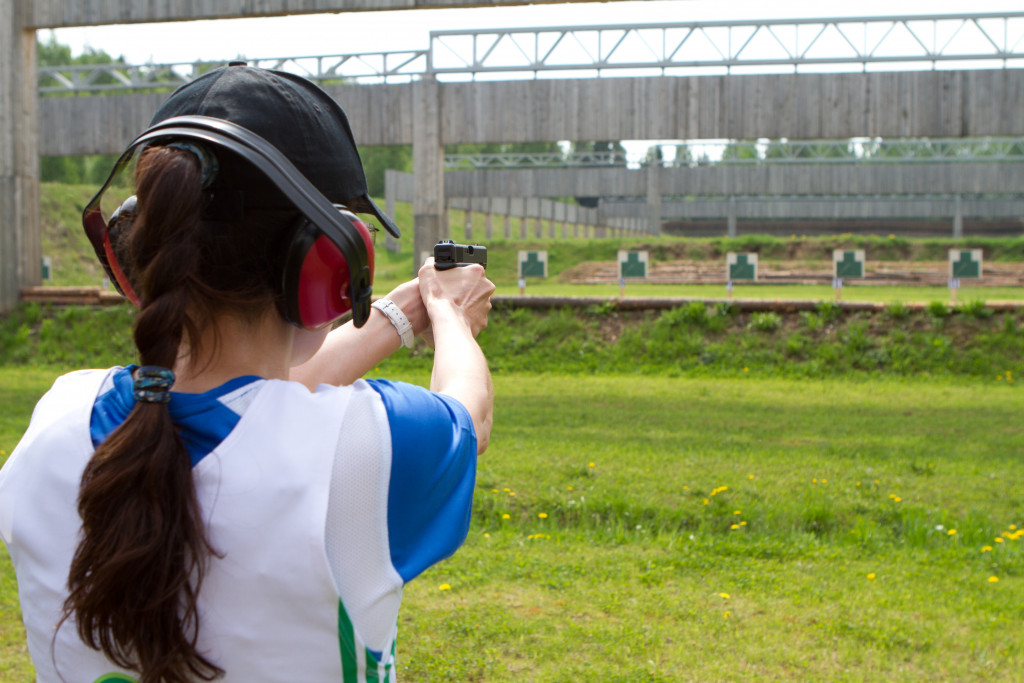 woman firing a gun in a shooting range