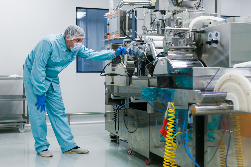 medical personnel looking at machinery