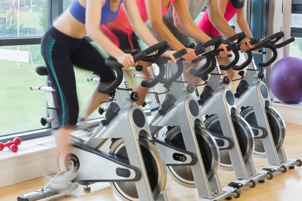 women using the stationary bike in the gym