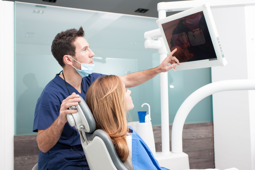 dentist pointing at a screen