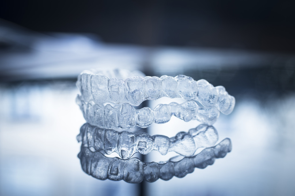 A set of removable invisible dental aligners on a glass table