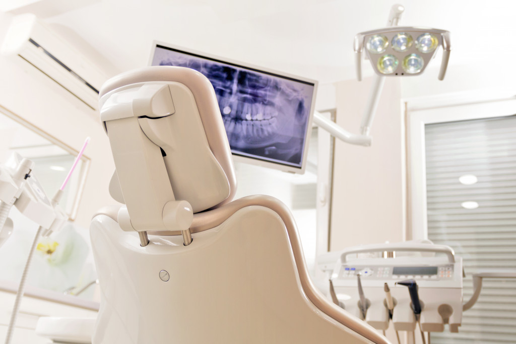 Modern dentist's chair with a monitor to show the mouth of a patient during examination.
