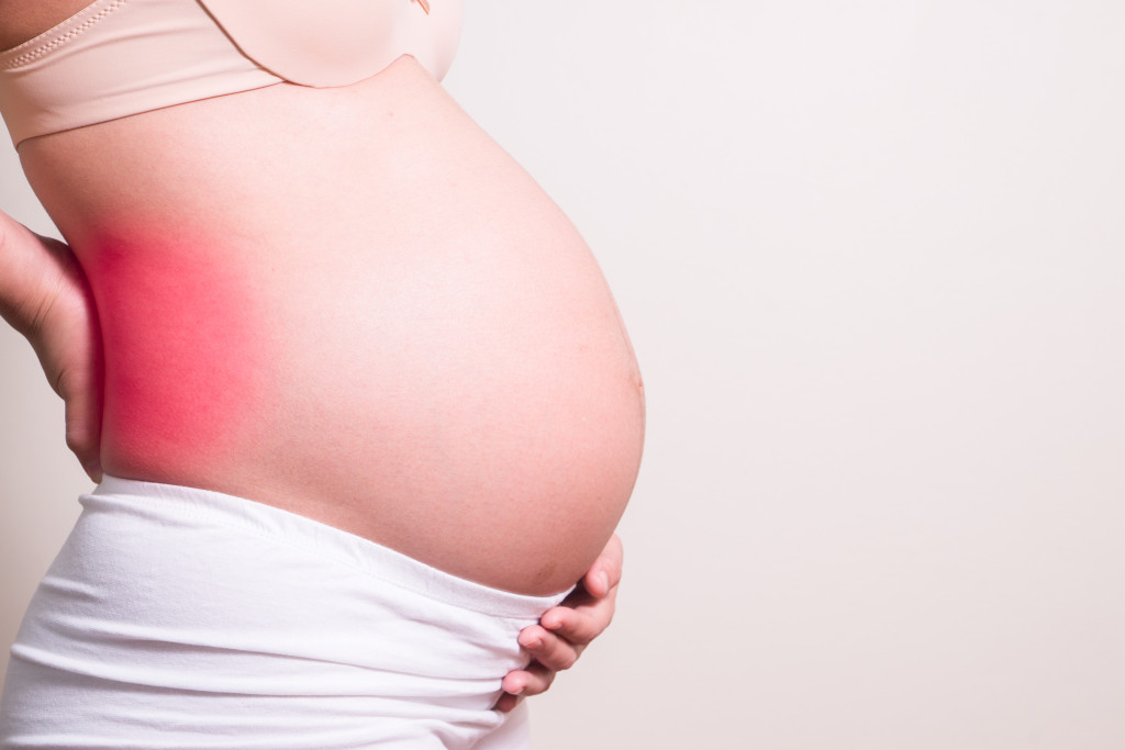 A pregnant woman experiencing severe backache