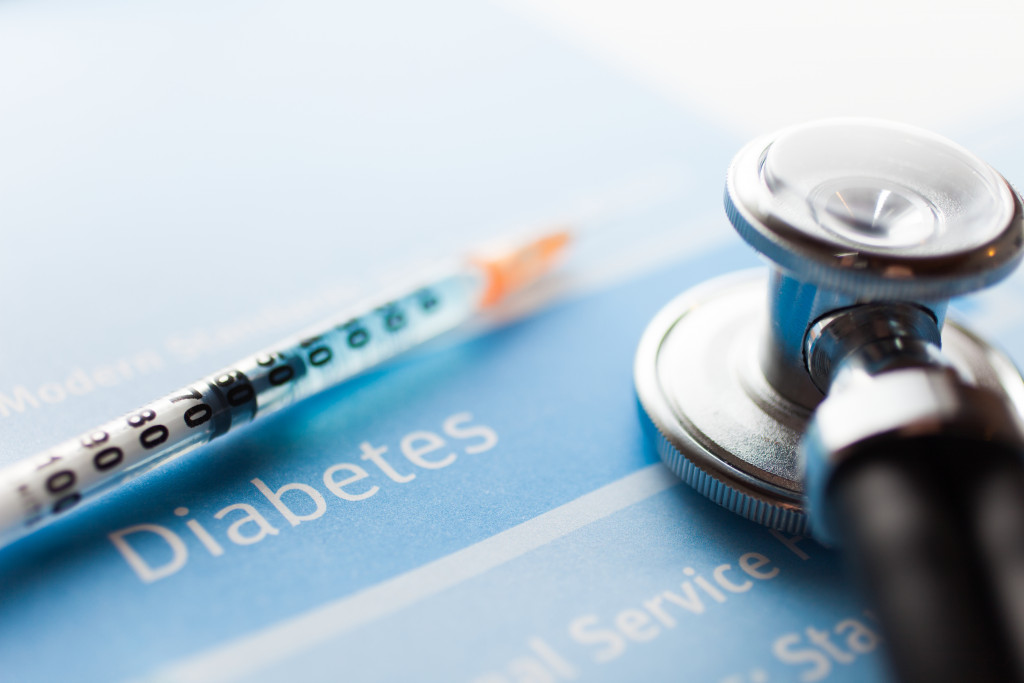 A syringe and a stethoscope on a diabetes test form