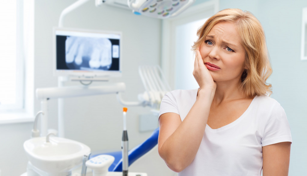 woman suffering toothache over at a dental office