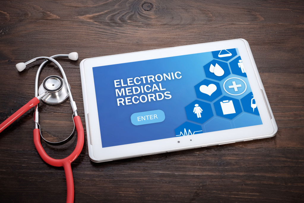 electronic medical records on tablet with stethoscope