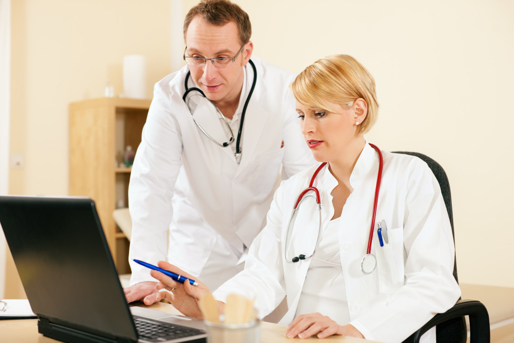 two doctors looking at digital document