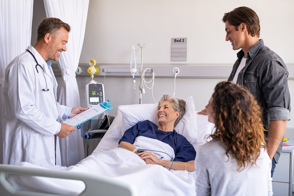 a doctor delivering good news to his patient to her patient's family