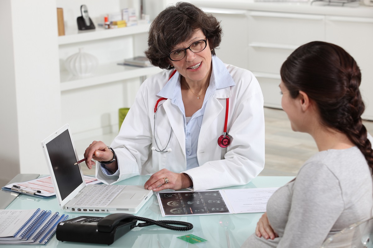 a female doctor discussing patients digital results